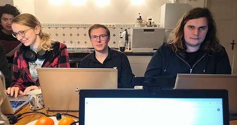 Auszubildende sitzen vor Laptops